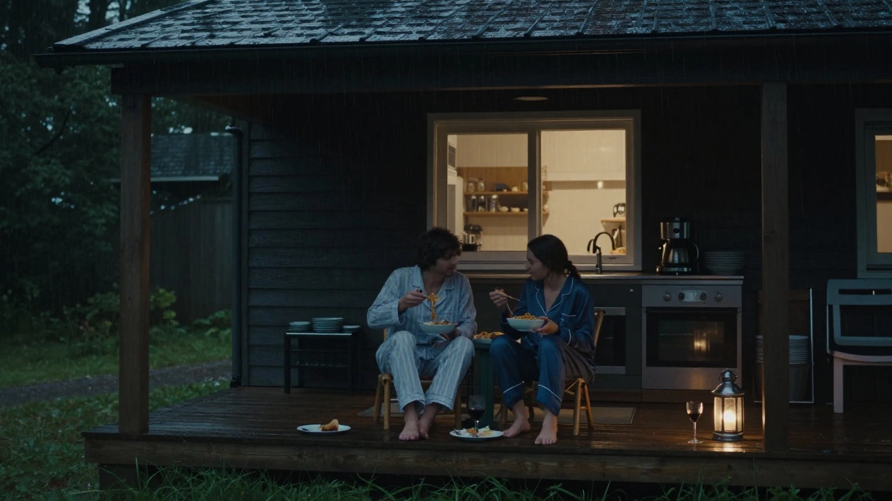 A couple eating pasta on a rainy evening porch, enjoying the freedom of self-catering.